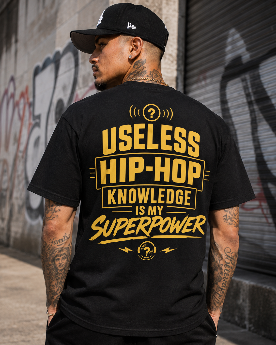 Superpower Tee worn from behind — Useless Hip-Hop Knowledge Is My Superpower printed across the back